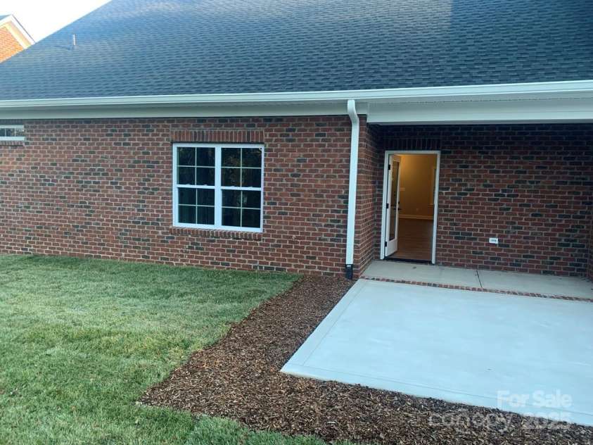 118 Abbington Lane, Shelby, NC 28150.  MLS# CAR4153289, YatesRealty ID 9083. View from back yard to patio and kitchen door
