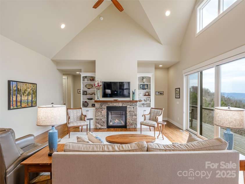 21 Alta Citta Lane, Asheville, NC 28804.  MLS# CAR4241580, YatesRealty ID 9090. Built-in cabinetry flanks the gas-log fireplace