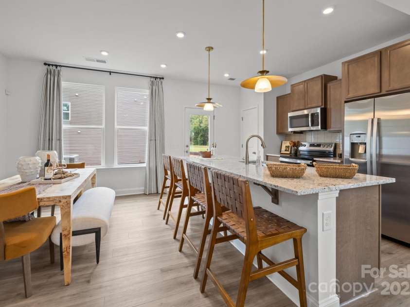 2233 Gladwyne Place, Charlotte, NC 28269.  MLS# CAR4330760, YatesRealty ID 910. Representative Photo from Model - Kitchen and Dining Area