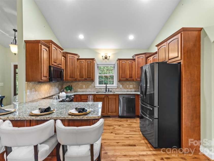1313 Western Hills Lane, Vale, NC 28168.  MLS# CAR4272544, YatesRealty ID 9105. Chef’s kitchen with granite countertops, stainless steel appliances, and timeless cabinetry.