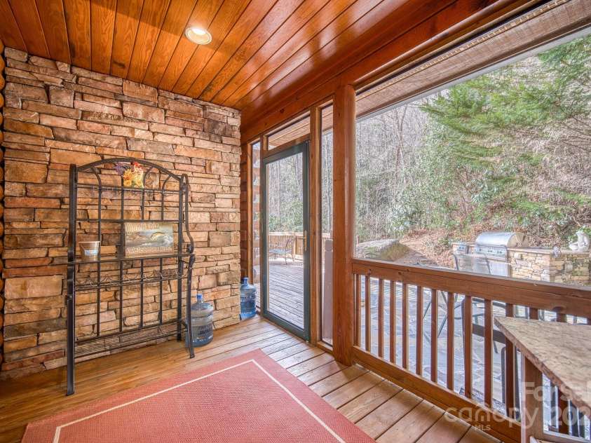 459 West Club Boulevard, Lake Toxaway, NC 28747.  MLS# CAR4220755, YatesRealty ID 911. Screened porch off dining area