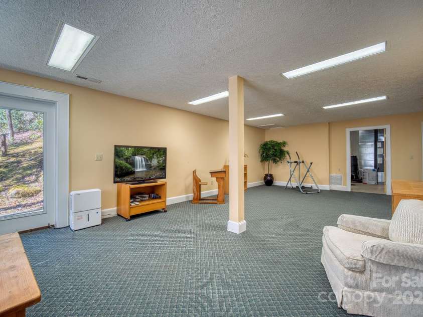 459 West Club Boulevard, Lake Toxaway, NC 28747.  MLS# CAR4220755, YatesRealty ID 911. Would make a great family room / home theatre