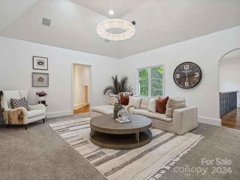 9044 Island Point Road, Charlotte, NC 28278.  MLS# CAR4135509, YatesRealty ID 912. The second-floor living room, distinguished by its majestic cathedral ceilings—a perfect sanctuary for entertaining guests in grand style located on the same floor as guests bedrooms.