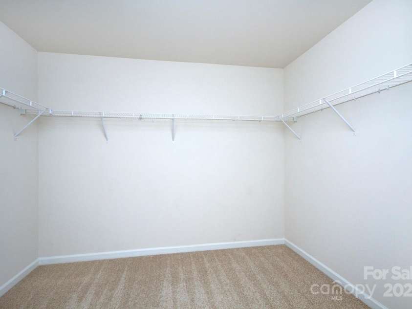 427 Carolina Hemlock Drive, Locust, NC 28097.  MLS# CAR4265067, YatesRealty ID 9127. Large walk-in closet in primary bedroom