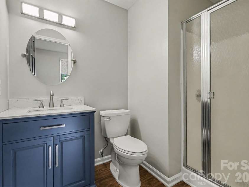 2114 Wilson Avenue, Charlotte, NC 28208.  MLS# CAR4391484, YatesRealty ID 9153. Primary bathroom with updated vanity, lighting, and mirror.