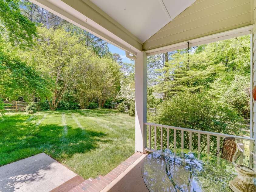 11003 Pale Hickory Lane, Charlotte, NC 28215.  MLS# CAR4234435, YatesRealty ID 9156. Enjoy your beautiful yard on this covered sun porch!