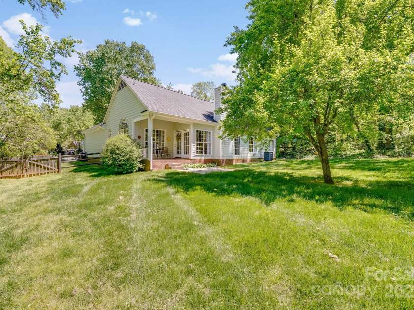 11003 Pale Hickory Lane, Charlotte, NC 28215.  MLS# CAR4234435, YatesRealty ID 9156. Large fenced yard surrounded by gorgeous trees and plants