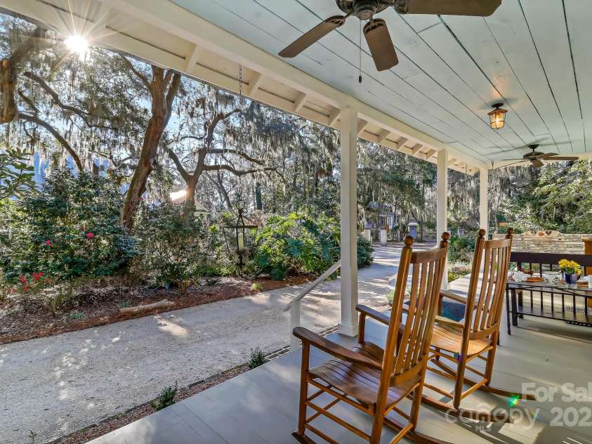 131 Pritchard Street, Bluffton, SC 29910.  MLS# CAR4214365, YatesRealty ID 916. Back to the guest house front porch overlooking the gardens with pathway and fountain. Sold furnished
