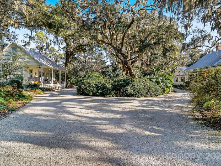 131 Pritchard Street, Bluffton, SC 29910.  MLS# CAR4214365, YatesRealty ID 916. Circular driveway with landscape center island separating the house from the guest house
