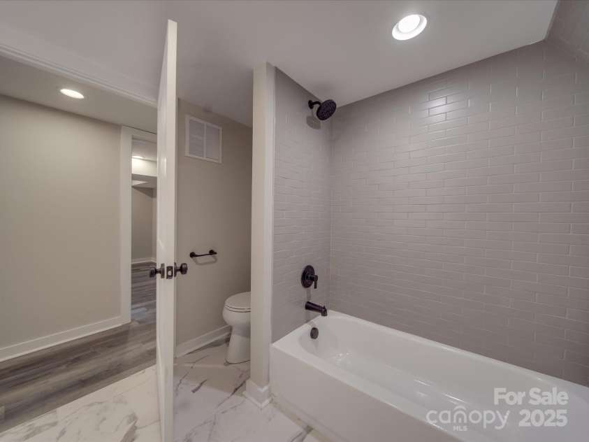 908 Davenport Street, Charlotte, NC 28208.  MLS# CAR4223250, YatesRealty ID 916. Downstairs bathroom