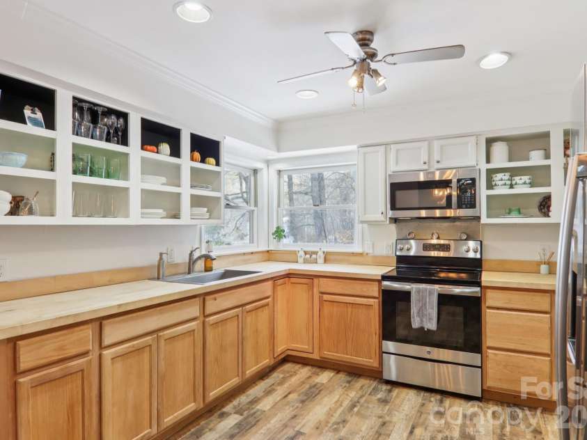 210 Spring Valley Drive, Mars Hill, NC 28754.  MLS# CAR4337752, YatesRealty ID 9192. Kitchen window looks out over the partially fenced in yard and tree house.
