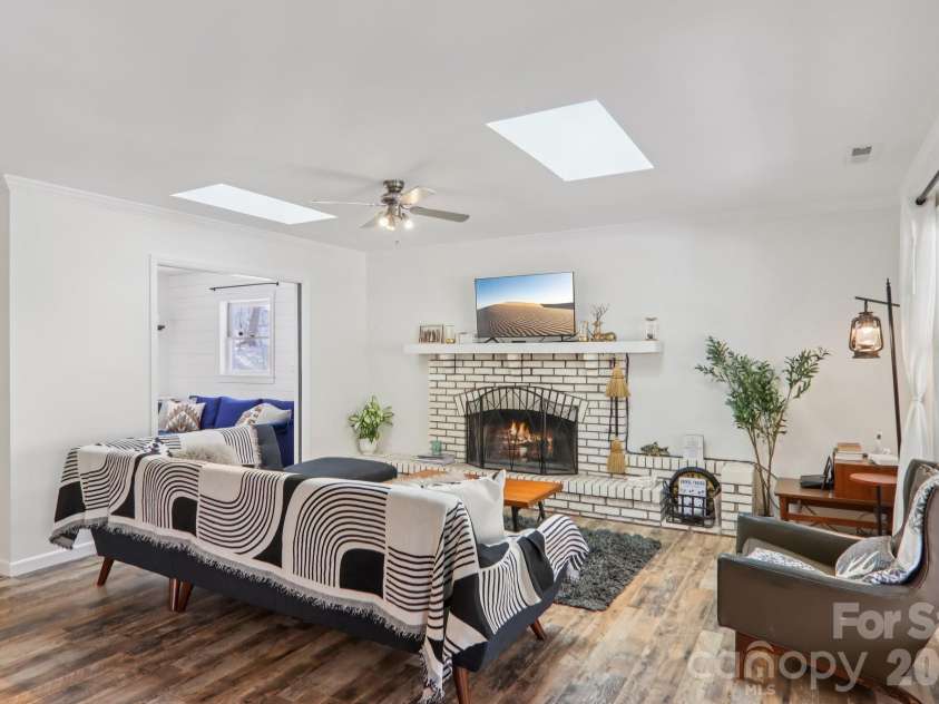 210 Spring Valley Drive, Mars Hill, NC 28754.  MLS# CAR4337752, YatesRealty ID 9192. Light filled living room with skylights and open fireplace. 