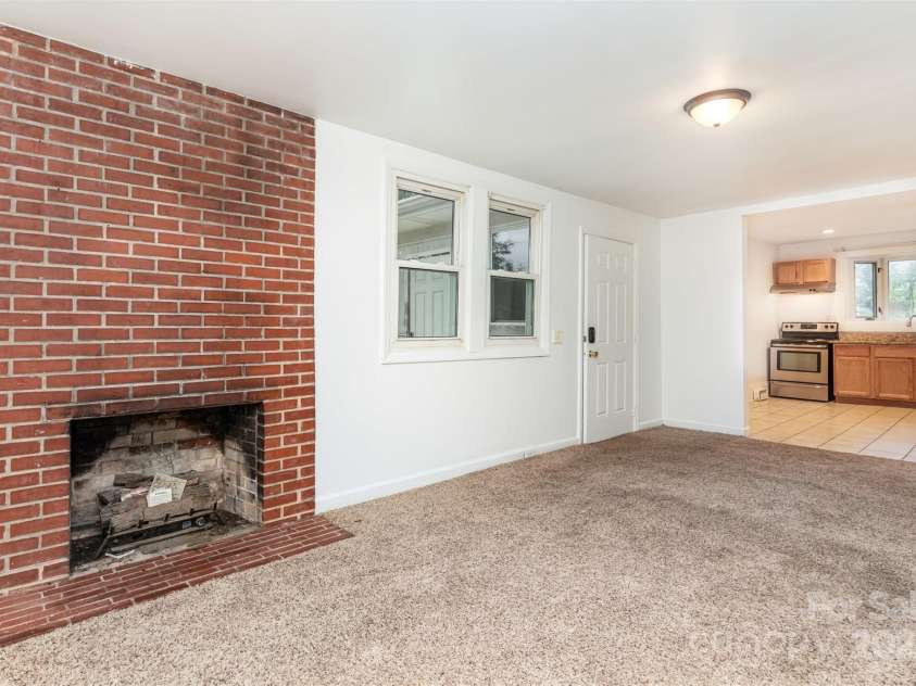 425 Maupin Avenue, Salisbury, NC 28144.  MLS# CAR4194348, YatesRealty ID 921. Family room with fireplace off kitchen