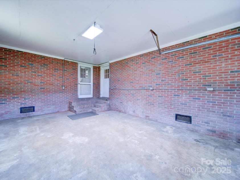 112 Highway 218 Road, Monroe, NC 28110.  MLS# CAR4125592, YatesRealty ID 9210. Garage with door to kitchen door on left  and door to office on the right