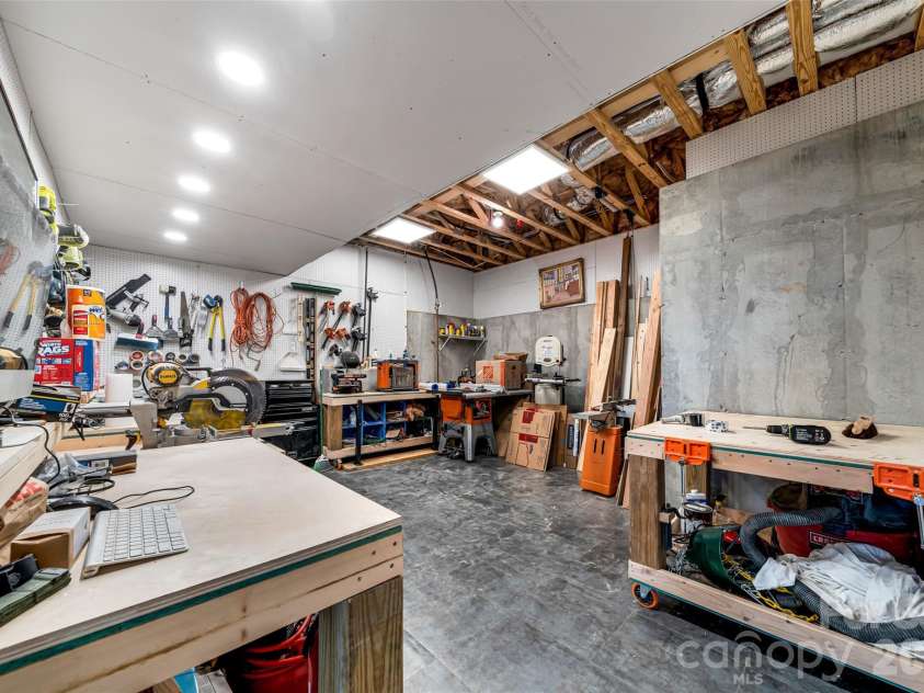 98 Rock Cliff Way, Hendersonville, NC 28791.  MLS# CAR4363363, YatesRealty ID 9260. Lower level workshop with storage