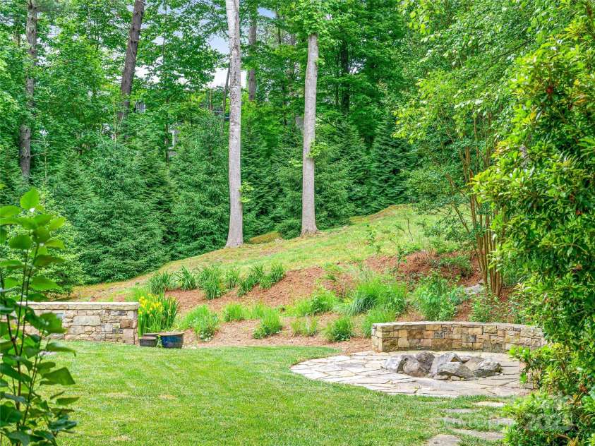 51 Robinhood Road, Asheville, NC 28804.  MLS# CAR4203746, YatesRealty ID 927. Fire pit area in large fenced back yard
