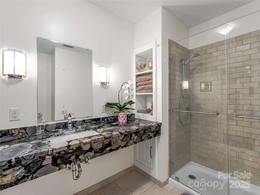 51 Robinhood Road, Asheville, NC 28804.  MLS# CAR4203746, YatesRealty ID 927. Lower level full bath with river stone granite