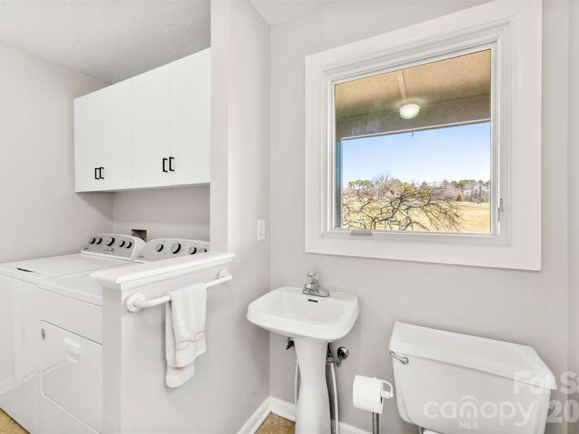 4242 John Ritchie Road, Iron Station, NC 28080.  MLS# CAR4350188, YatesRealty ID 9296. Half Bathroom in Mudroom w/Laundry