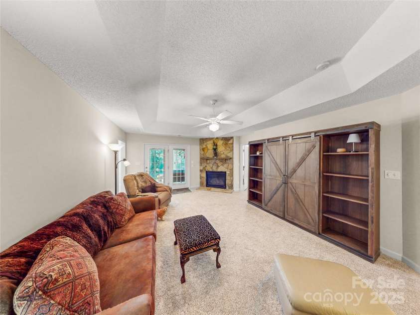 115 Keswick Lane, Mooresville, NC 28117.  MLS# CAR4245086, YatesRealty ID 9299. Looking toward the fireplace and French doors to the sunroom!