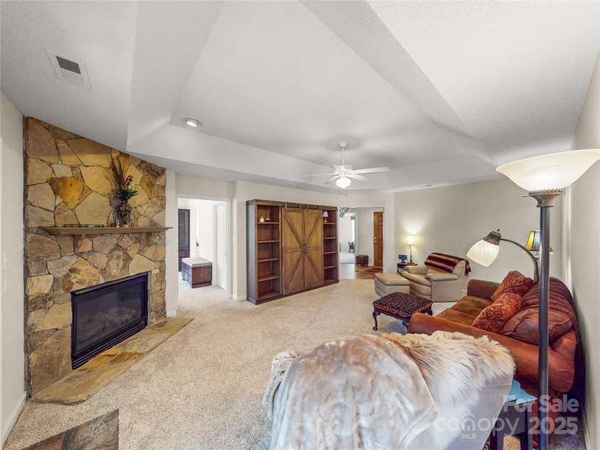 115 Keswick Lane, Mooresville, NC 28117.  MLS# CAR4245086, YatesRealty ID 9299. Spacious Living Room with gas log fireplace, trey ceiling and new carpeting!