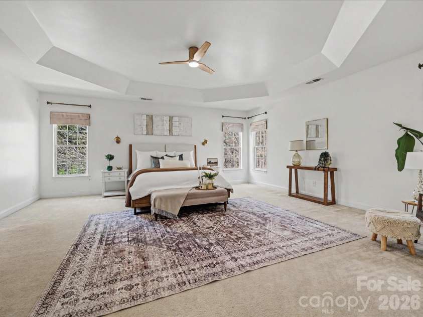 108 Braxton Gate Court, Mount Holly, NC 28120.  MLS# CAR4351876, YatesRealty ID 9308. Spacious primary suite featuring a tray ceiling, multiple windows for natural light, and plenty of room for a private sitting area.