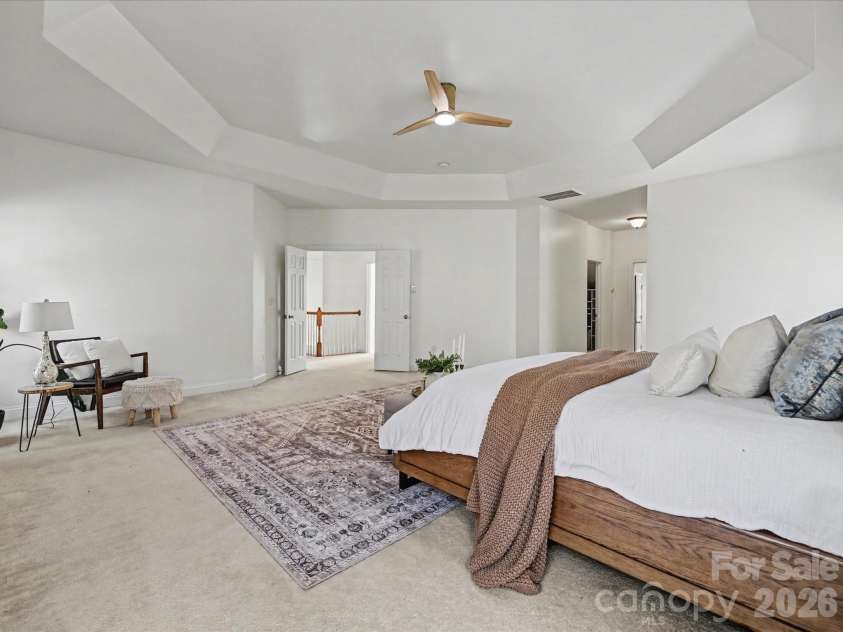 108 Braxton Gate Court, Mount Holly, NC 28120.  MLS# CAR4351876, YatesRealty ID 9308. Spacious primary suite featuring a tray ceiling, multiple windows for natural light, and plenty of room for a private sitting area.