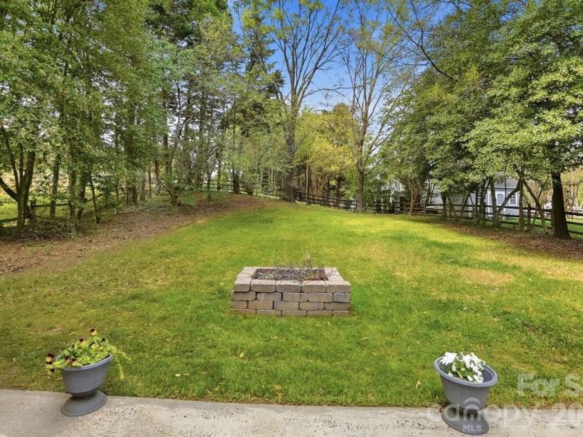 8912 Danson Drive, Charlotte, NC 28277.  MLS# CAR4364378, YatesRealty ID 9321. Private, tree-lined backyard offering space to relax, play, or entertain outdoors.
