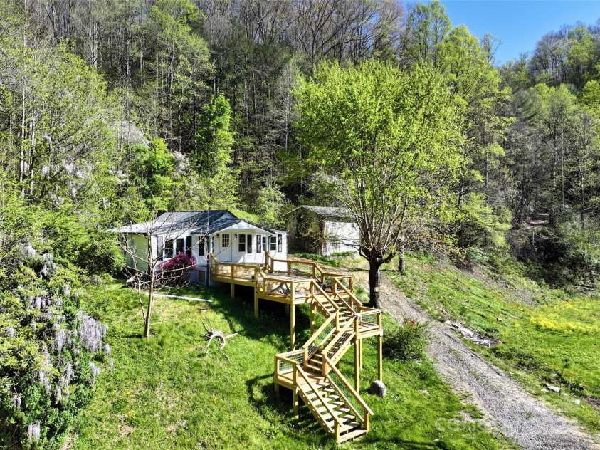 2180 Pigeon Roost Road, Green Mountain, NC 28740.  MLS# CAR4137054, YatesRealty ID 9333. Aerial view of remodeled farmhouse and new deck