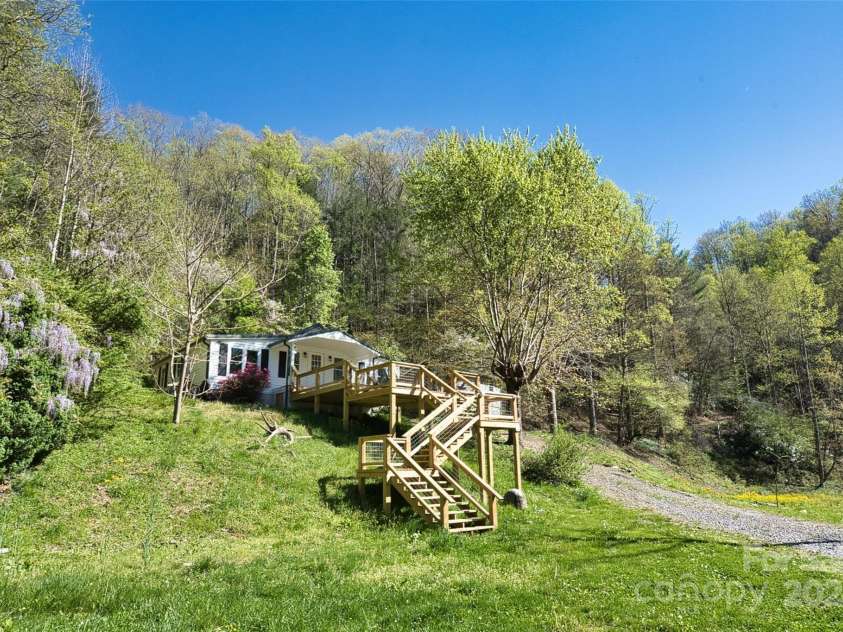 2180 Pigeon Roost Road, Green Mountain, NC 28740.  MLS# CAR4137054, YatesRealty ID 9333. Another angle on the farmhouse and new deck