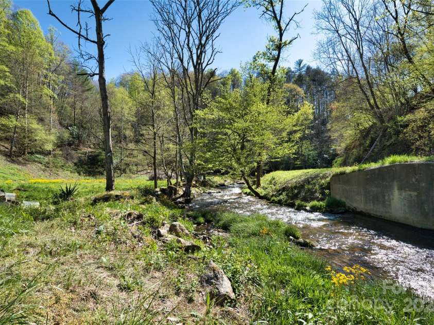2180 Pigeon Roost Road, Green Mountain, NC 28740.  MLS# CAR4137054, YatesRealty ID 9333. Bold, cheerful Pigeon Roost Creek at the farmhouse