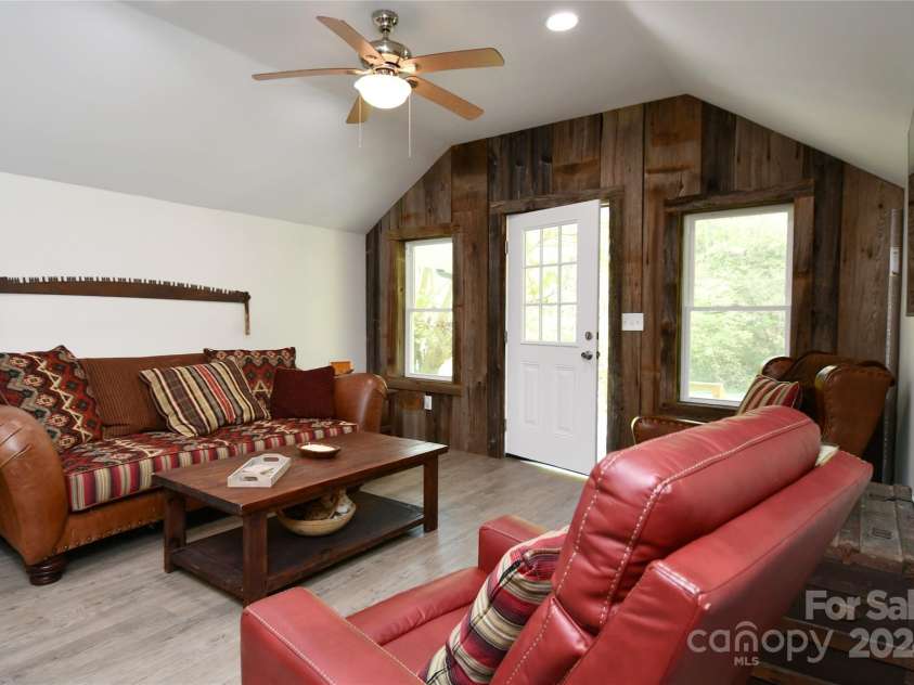 2180 Pigeon Roost Road, Green Mountain, NC 28740.  MLS# CAR4137054, YatesRealty ID 9333. Living Room utilizes gorgeous weathered barnwood from property