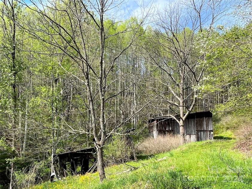 2180 Pigeon Roost Road, Green Mountain, NC 28740.  MLS# CAR4137054, YatesRealty ID 9333. Old barns off the hidden meadow