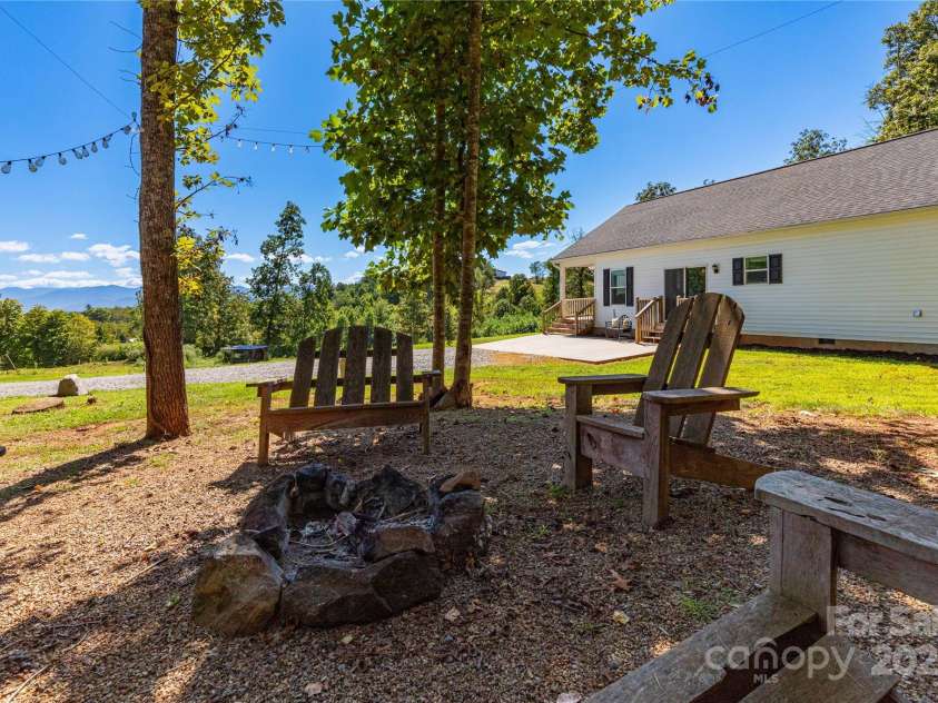 653 Mag Sluder Road, Alexander, NC 28701.  MLS# CAR4299475, YatesRealty ID 934. Fire Pit area side yard