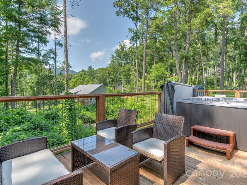 122 Cascade Ridge Road, Fairview, NC 28730.  MLS# CAR4227423, YatesRealty ID 9343. Back deck with hot tub great for entertaining