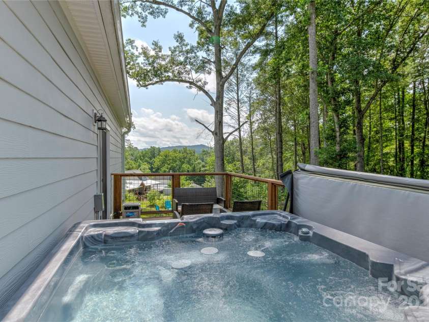 122 Cascade Ridge Road, Fairview, NC 28730.  MLS# CAR4227423, YatesRealty ID 9343. Back deck with hot tub great for entertaining