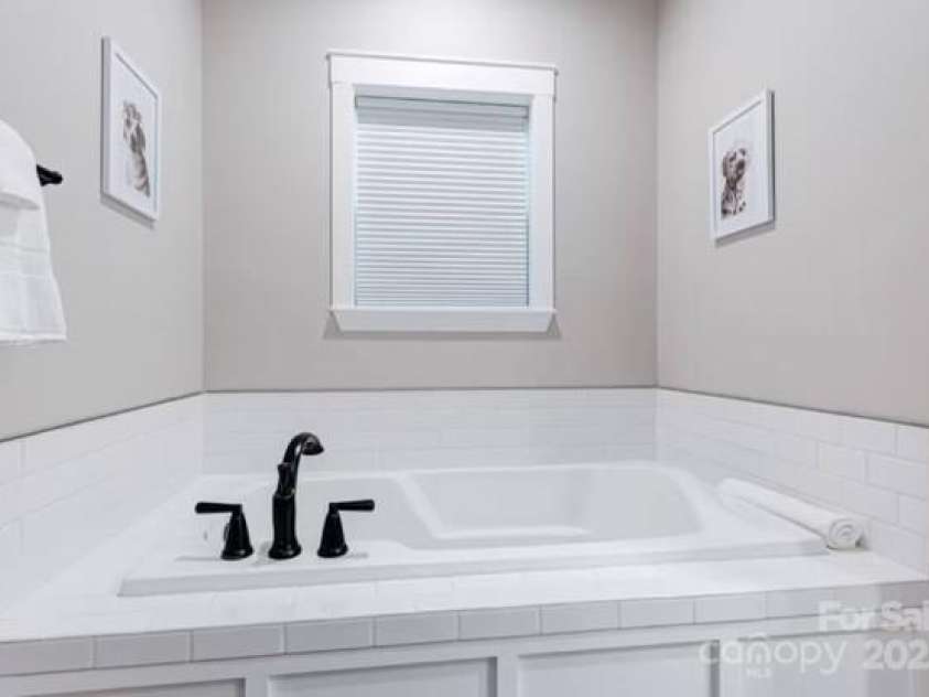 122 Cascade Ridge Road, Fairview, NC 28730.  MLS# CAR4227423, YatesRealty ID 9343. Master bathroom with soaking tub and walk in shower