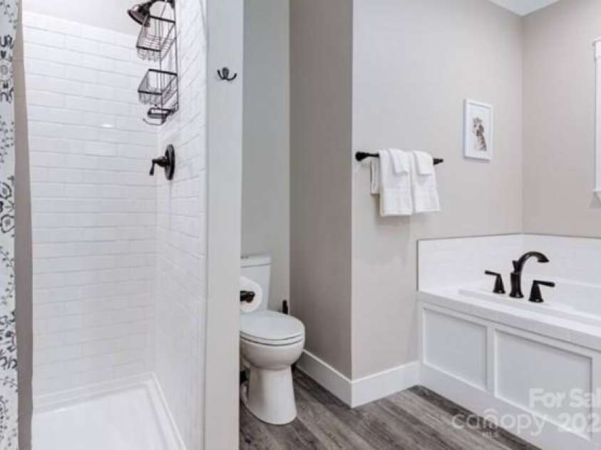122 Cascade Ridge Road, Fairview, NC 28730.  MLS# CAR4227423, YatesRealty ID 9343. Master bathroom with soaking tub and walk in shower