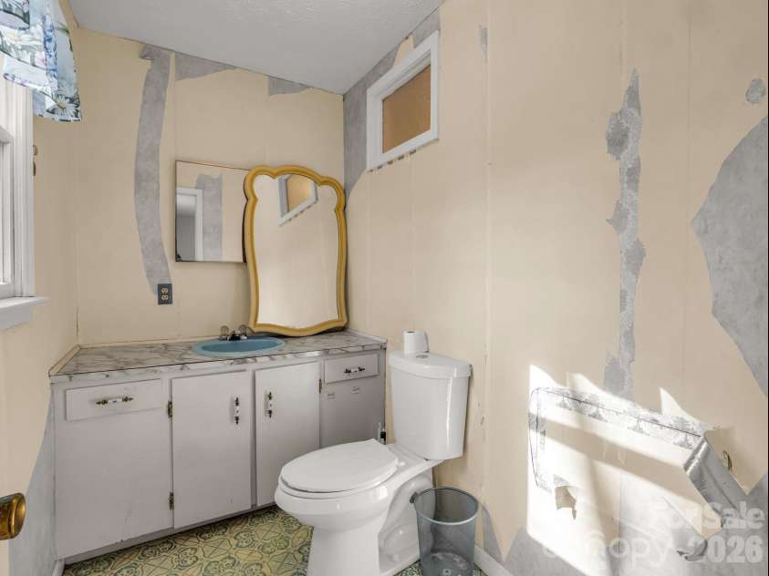 755 Mount Olivet Road, Zirconia, NC 28790.  MLS# CAR4336609, YatesRealty ID 9345. Half bath in primary suite