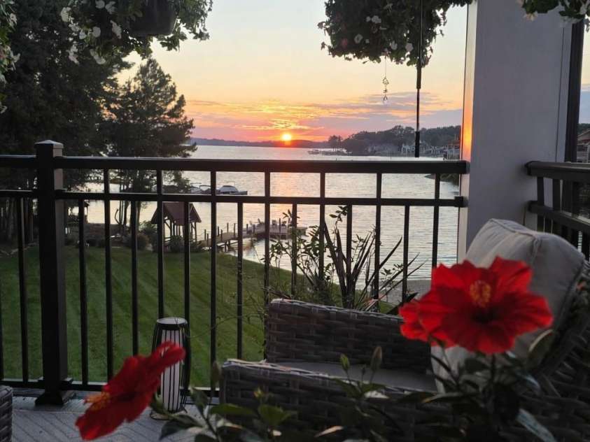 17810 Half Moon Lane, Cornelius, NC 28031.  MLS# CAR4248678, YatesRealty ID 9348. Lakeside sunset with hibiscus blooms