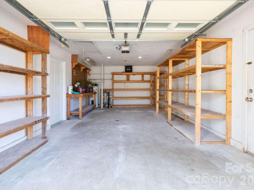 7 McGee Ridge Road, Fairview, NC 28730.  MLS# CAR4327576, YatesRealty ID 9362. Garage with shelving for additional storage. 