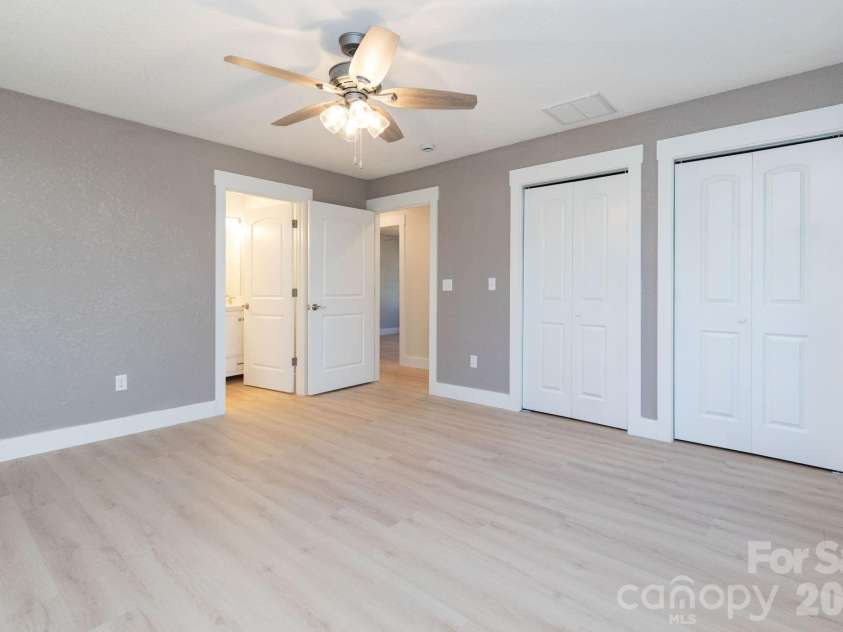 7 McGee Ridge Road, Fairview, NC 28730.  MLS# CAR4327576, YatesRealty ID 9362. Primary bedroom with double closets, and en suite. 