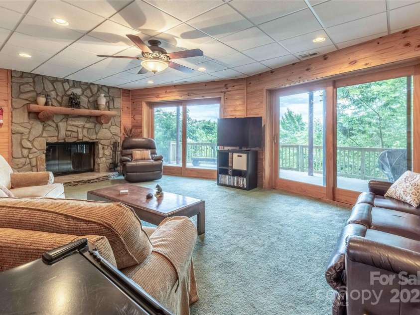 278 Talisi Trail, Whittier, NC 28789.  MLS# CAR4240743, YatesRealty ID 9363. Lower living room with wood burning fireplace