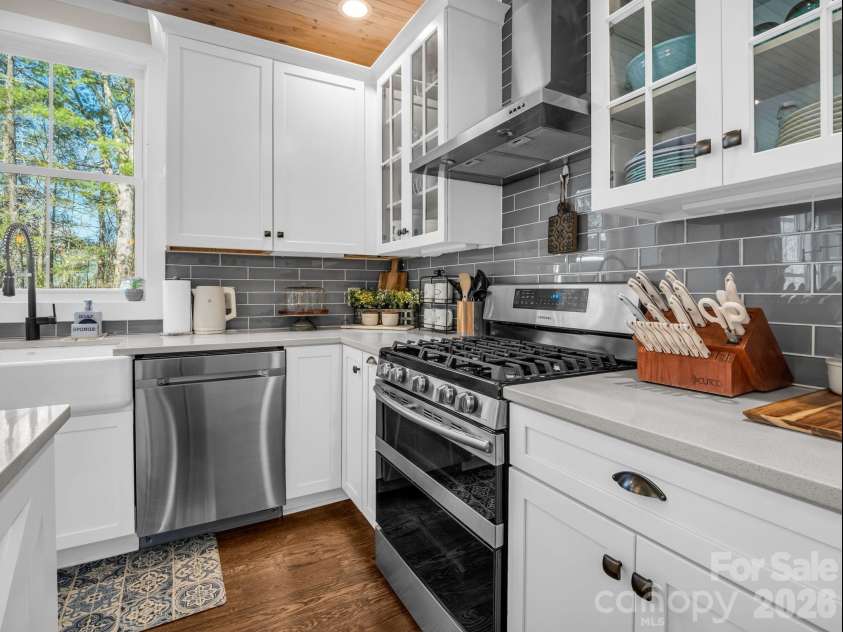 52 Old Spring Drive, Candler, NC 28715.  MLS# CAR4360930, YatesRealty ID 9363. Kitchen features custom cabinetry, stainless appliances and quartz counters, hood vent