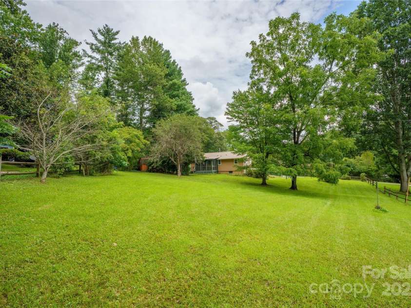 45 Armstrong Road, Etowah, NC 28729.  MLS# CAR4276177, YatesRealty ID 9369. Large backyard with fruit trees