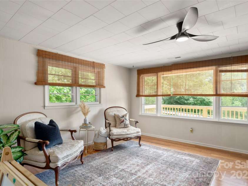 45 Armstrong Road, Etowah, NC 28729.  MLS# CAR4276177, YatesRealty ID 9369. Living room with wood stove