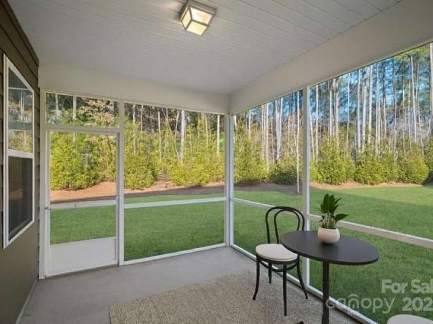116 Van Gogh Trail, Mount Holly, NC 28120.  MLS# CAR4213955, YatesRealty ID 9371. Virtually staged screened porch off primary bedroom