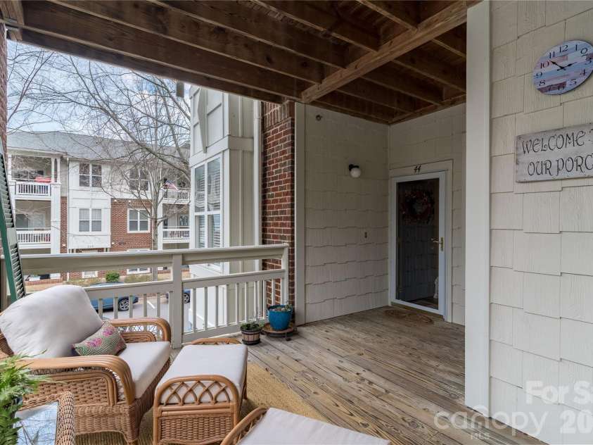 714 Northeast Drive, Davidson, NC 28036.  MLS# CAR4349837, YatesRealty ID 9377. Sit and relax with a book on your front porch.