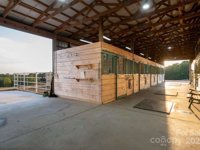 822 & 920 Preservation Trail, Columbus, NC 28722.  MLS# CAR4223854, YatesRealty ID 9386. Looking east from center of barn aisle
