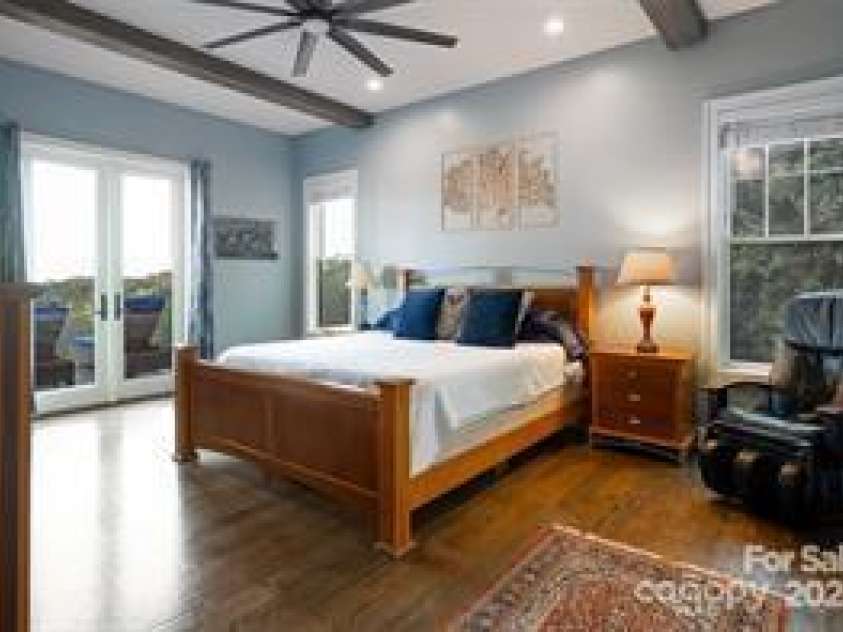 822 & 920 Preservation Trail, Columbus, NC 28722.  MLS# CAR4223854, YatesRealty ID 9386. Main house primary bedroom with access to deck
