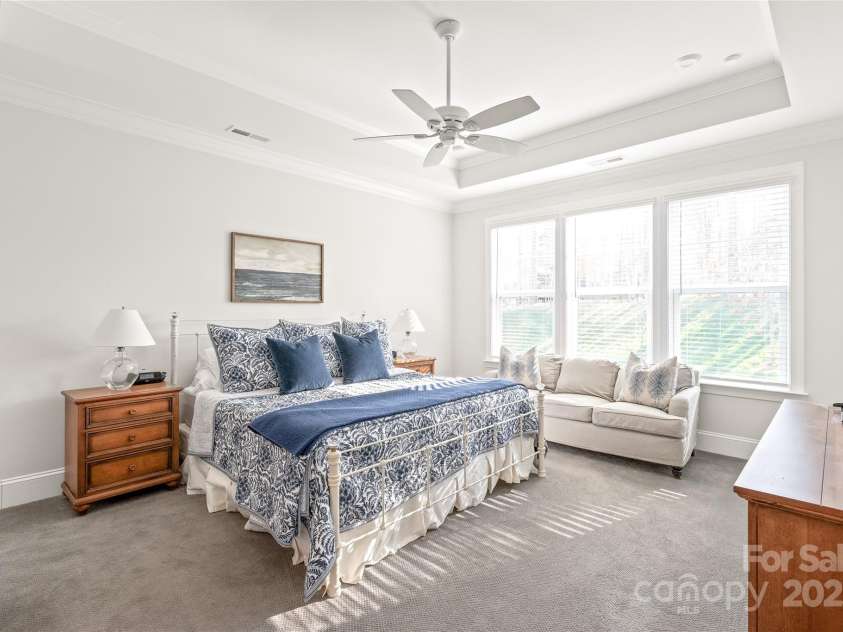 128 Shimmer Lake Lane, Belmont, NC 28012.  MLS# CAR4208573, YatesRealty ID 9390. A private retreat on the main level! The primary bedroom features elegant tray ceilings and a dream closet, offering both comfort and luxury.